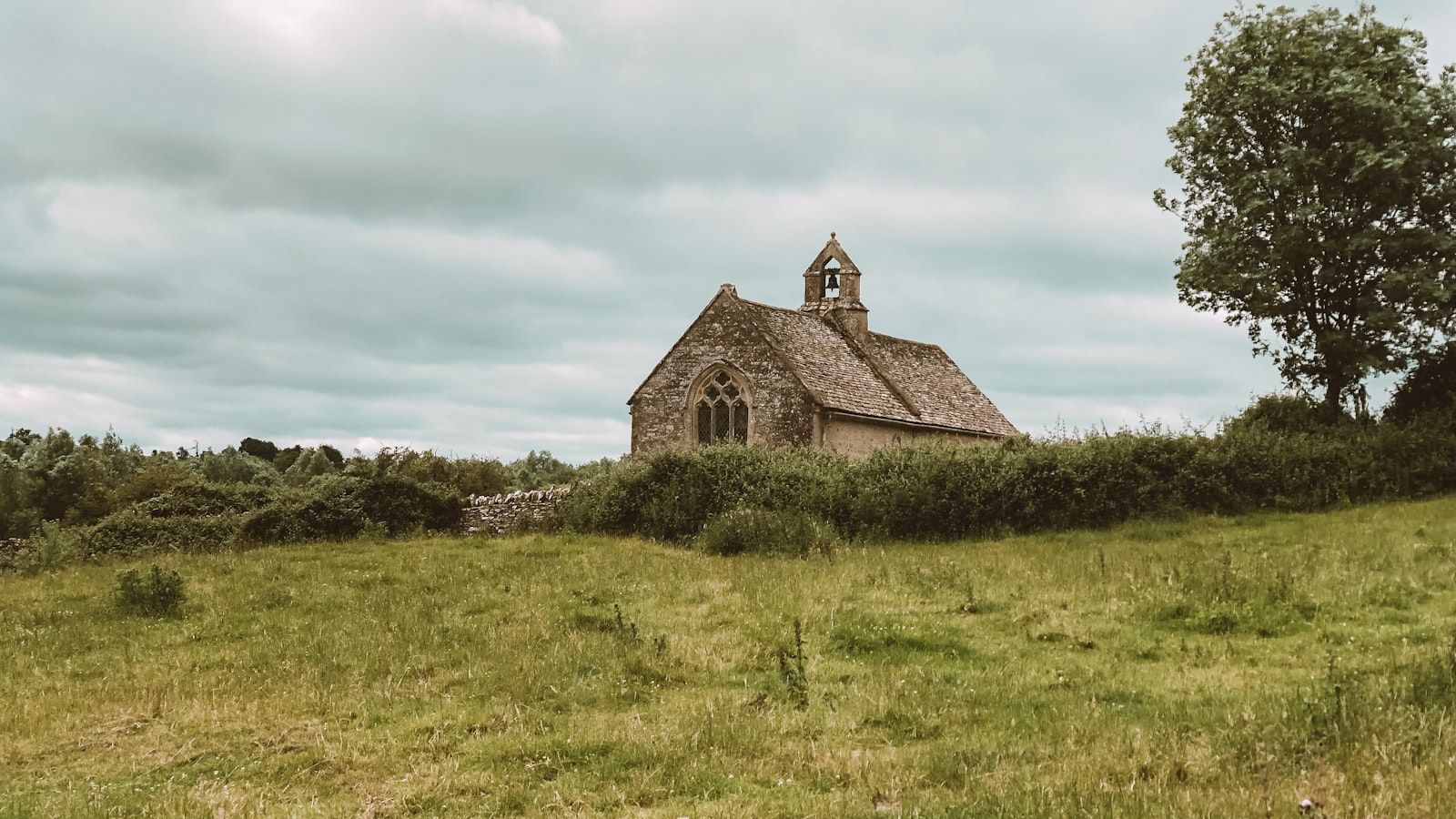 Petite église de pierre isolée dans un pré